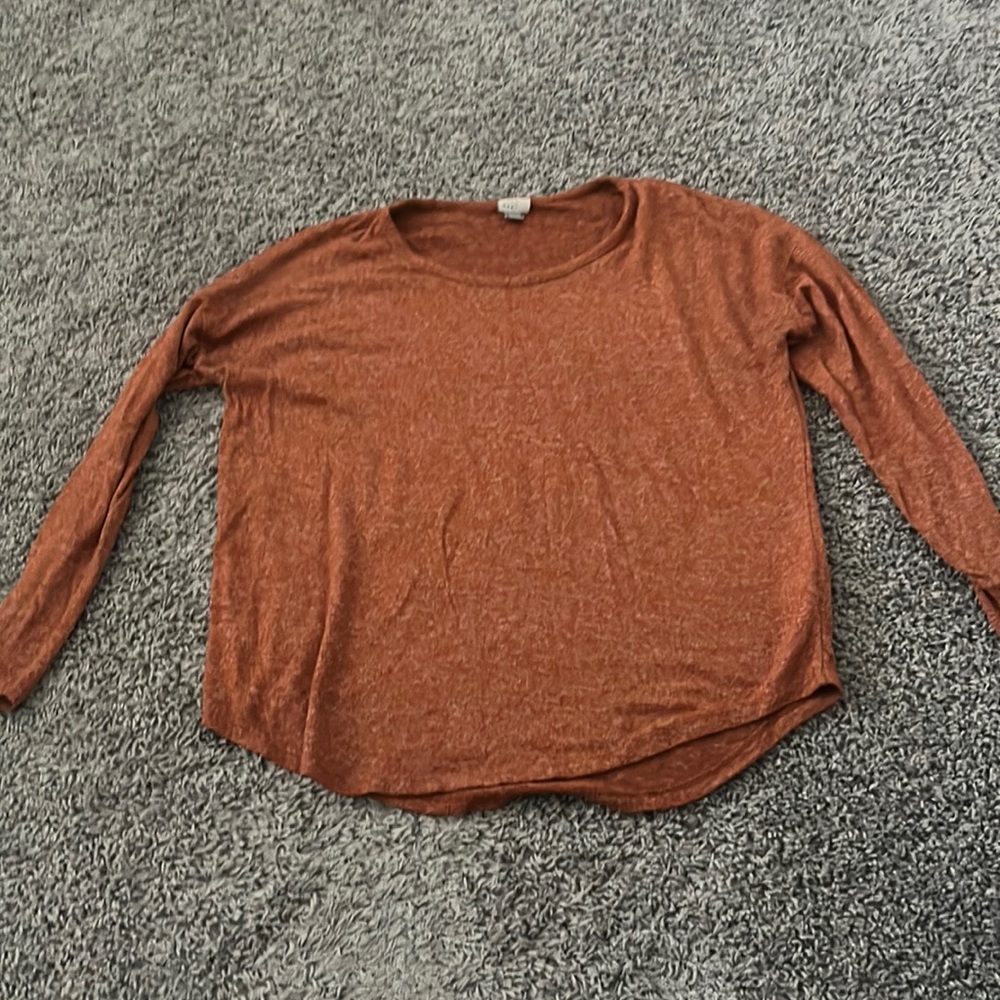 Long sleeved, medium orange shirt made out of cotton very soft